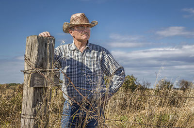 Full length of man standing on field against sky