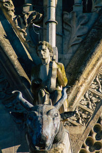 Statue of man holding sculpture