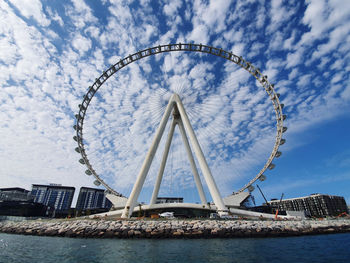 Ferris wheel in city against sky