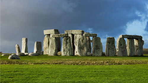 Built structure on field against cloudy sky