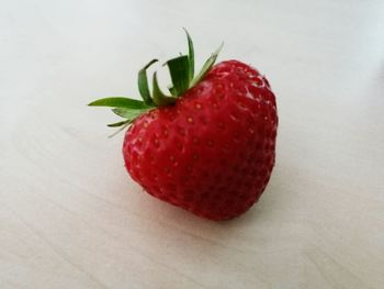 Close-up of red fruit over white background