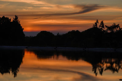 Scenic view of lake against orange sky