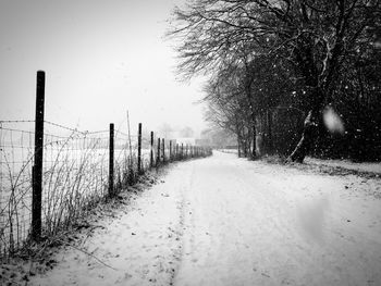 Snow covered field against sky