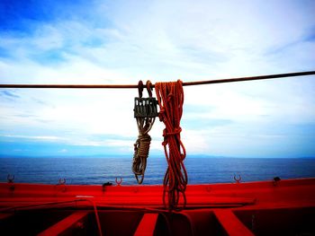 Rope hanging on boat against sky