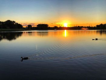 Scenic view of lake against sky during sunset