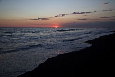 Scenic view of sea against sky at sunset