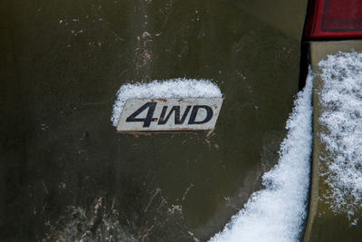 Close-up of snow covered sign