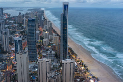 Aerial cityscape of modern city with skysrapers and tall office buildings along the ocean coastline