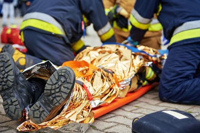 Rescuers provide first aid to the victim during car road accident