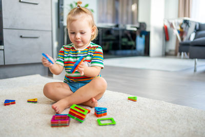 Portrait of boy playing with toy blocks at home