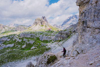 Full length of man walking on mountain against sky