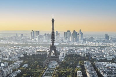 Aerial view of buildings in city at sunset