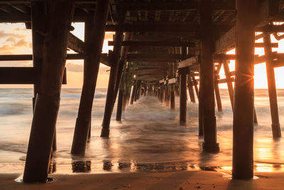 Low angle view of bridge at calm sea