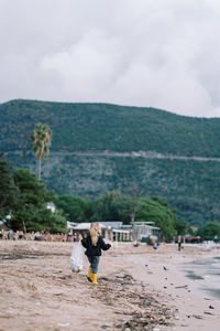 Rear view of woman walking on beach