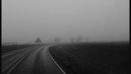 Road passing through foggy weather