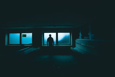 Silhouette man in illuminated room