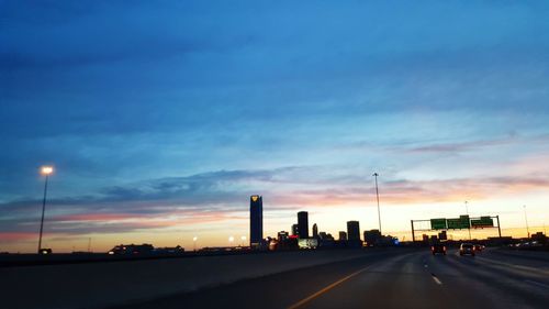 Cars on road at sunset