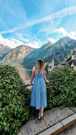 Rear view of woman standing on mountain