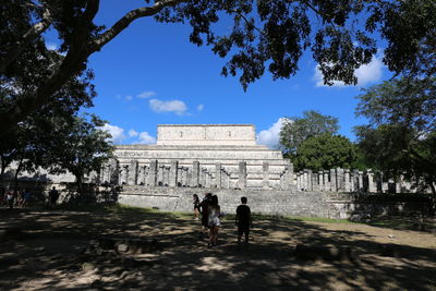 People walking in front of historical building