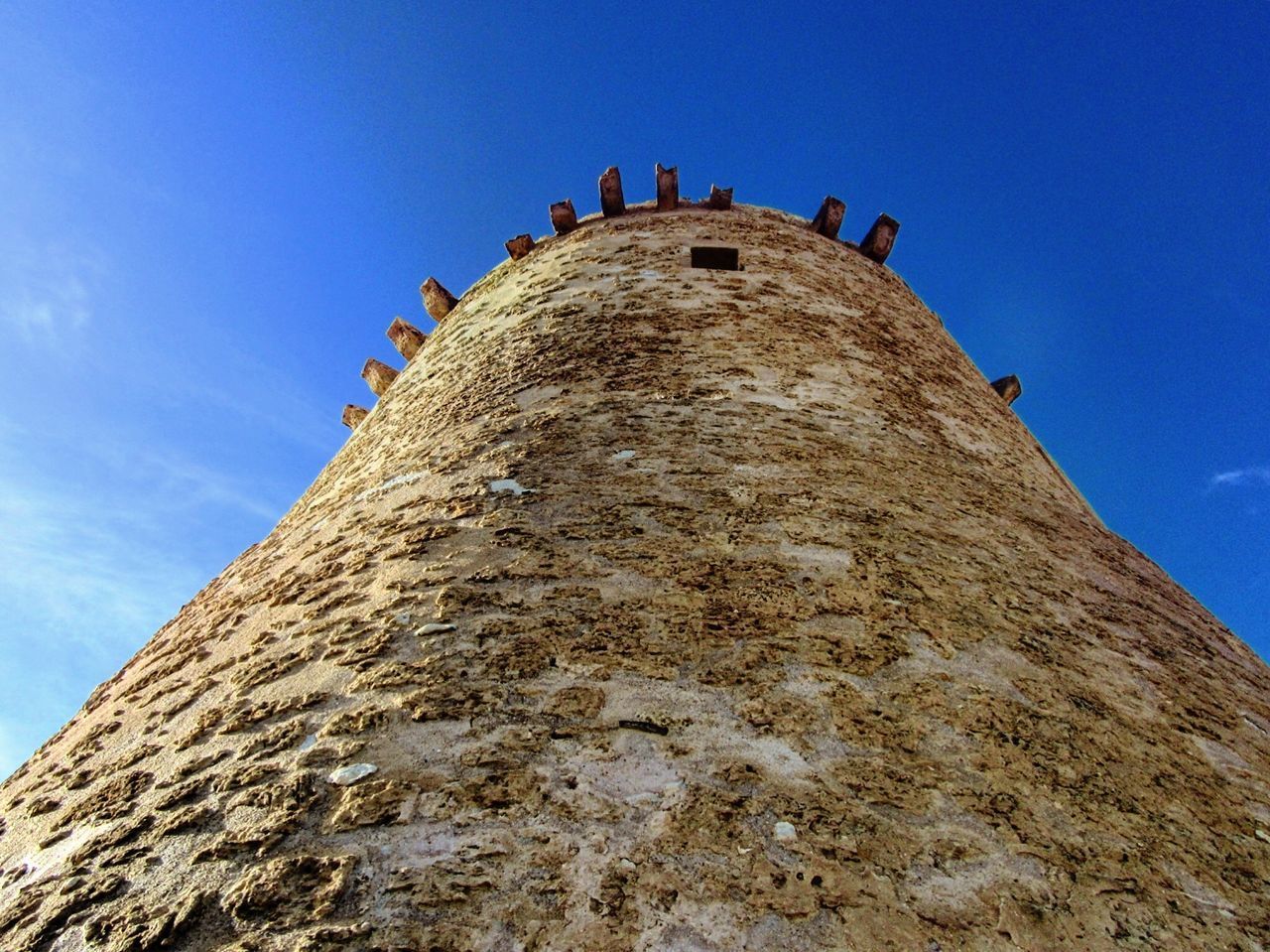 LOW ANGLE VIEW OF CASTLE TOWER AGAINST BLUE SKY