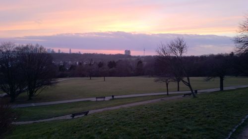 Scenic view of grassy field against cloudy sky