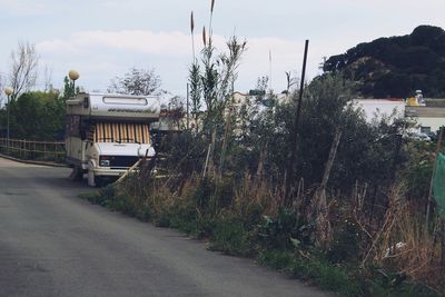 Empty road along buildings