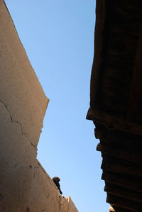 Low angle view of historical building against clear blue sky