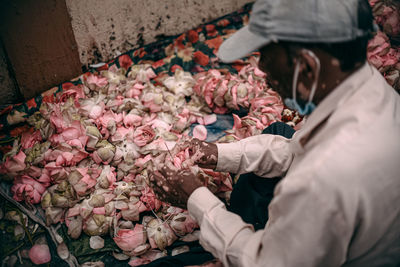 Midsection of man for sale at market stall