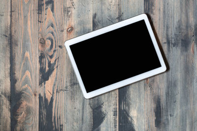 Close-up of smart phone on wooden table