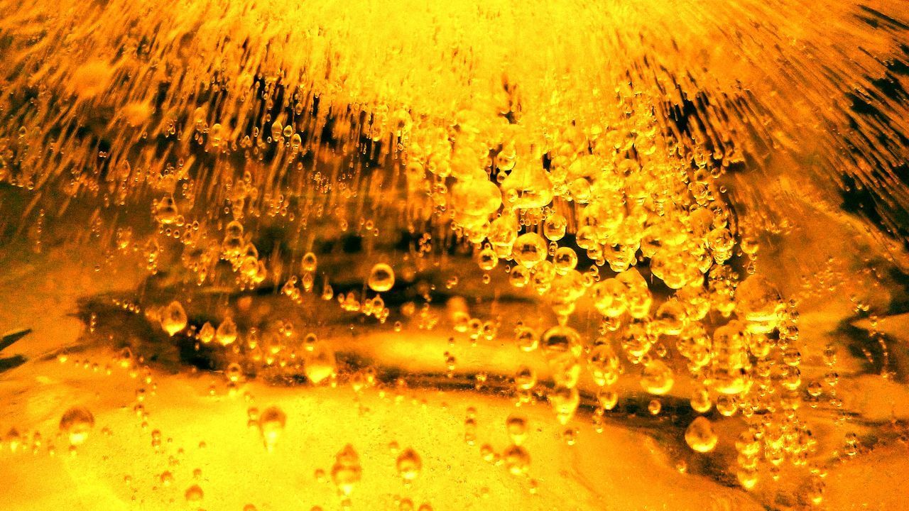 FULL FRAME SHOT OF WATER DROPS ON YELLOW CAR