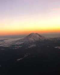 Scenic view of snowcapped mountains against sky during sunset