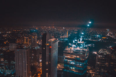 Aerial view of city lit up at night