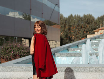 Portrait of smiling young woman standing outdoors