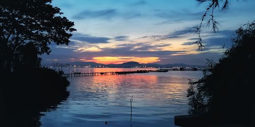 Scenic view of lake against orange sky
