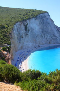 Scenic view of turquoise beach against clear blue sky