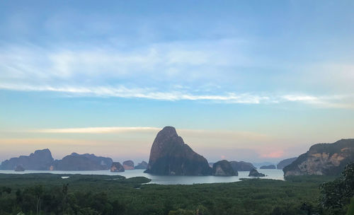 Scenic view of sea and mountains against sky