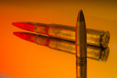 Close-up of cigarette against orange background