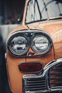 Cropped image of orange vintage car parked outdoors