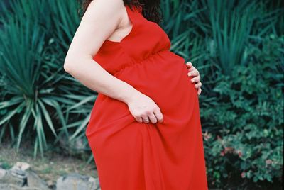 Midsection of woman standing on field