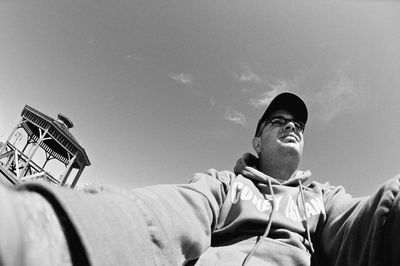 Low angle view of man and woman against sky