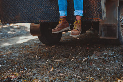 Low section of woman sitting in truck