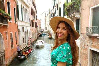 Portrait of smiling young woman in canal