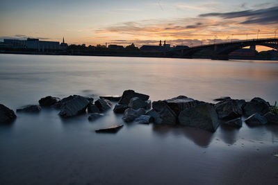 Scenic view of river against sky during sunset