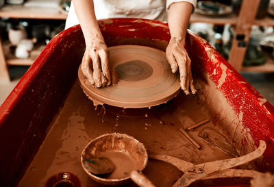 Midsection of man preparing food in workshop