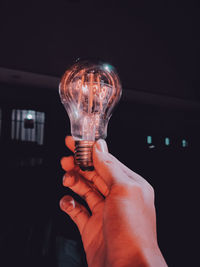 Close-up of hand holding light bulb