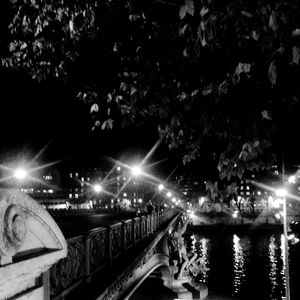 Illuminated bridge at night