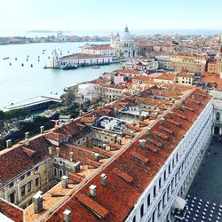 High angle view of buildings by canal in city