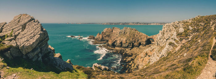 High angle view of rocks in sea against clear sky