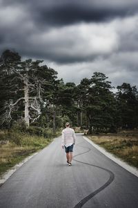 View of country road against cloudy sky