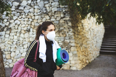 Woman wearing mask walking outdoors